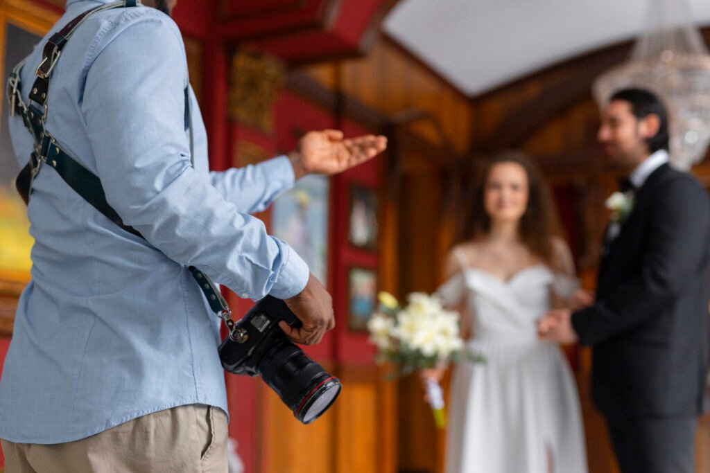 A photographer gesturing to direct a posing couple, highlighting the skills of female photographers and portrait photographers Karachi Wedding Photography