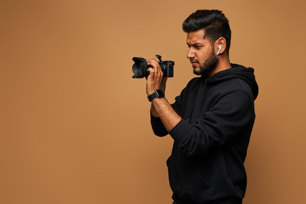 A professional photographer capturing a bride and groom during an indoor shoot, showcasing high-quality wedding photography services by a photographer in Karachi